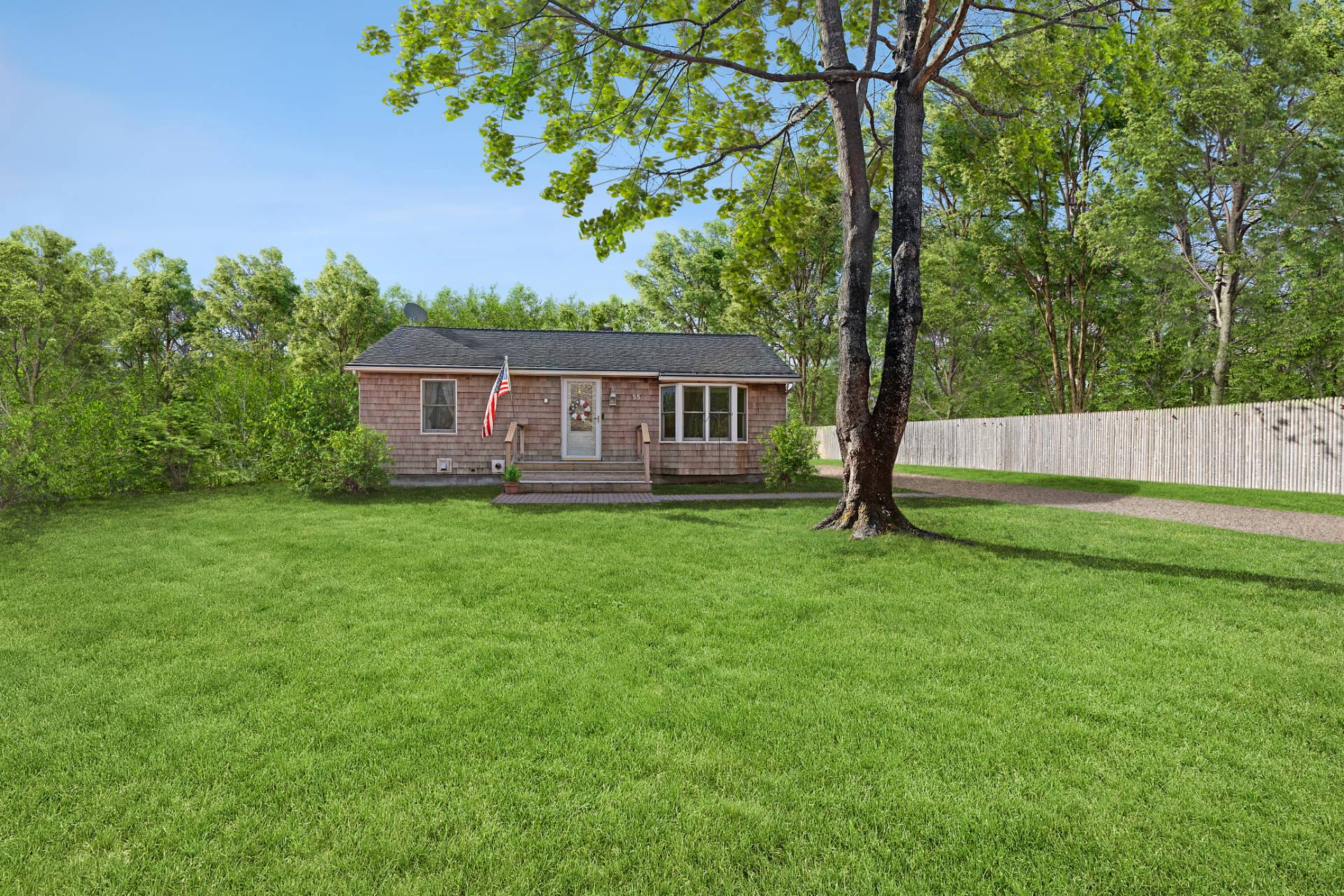 a view of house with backyard and a garden