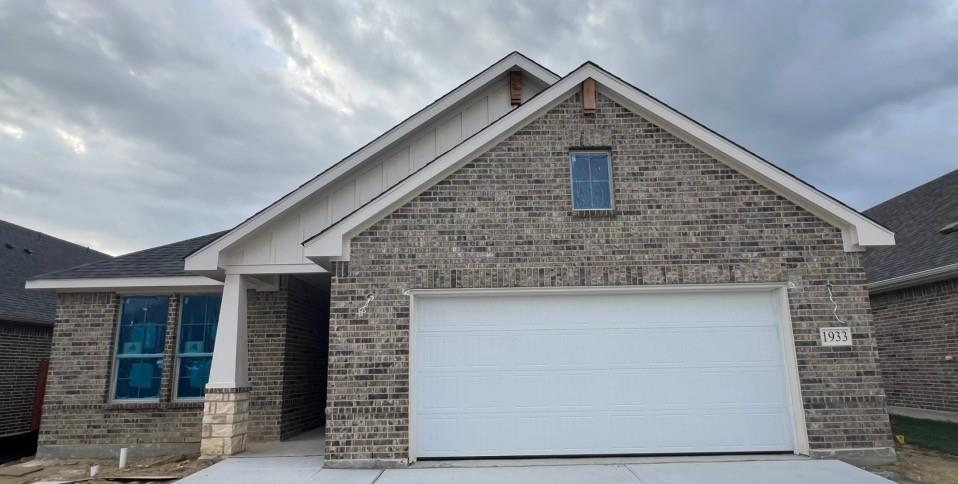 a front view of a house with garage