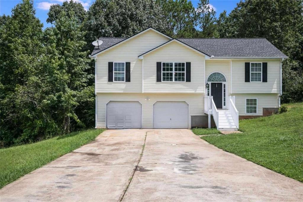 a front view of a house with a yard and garage