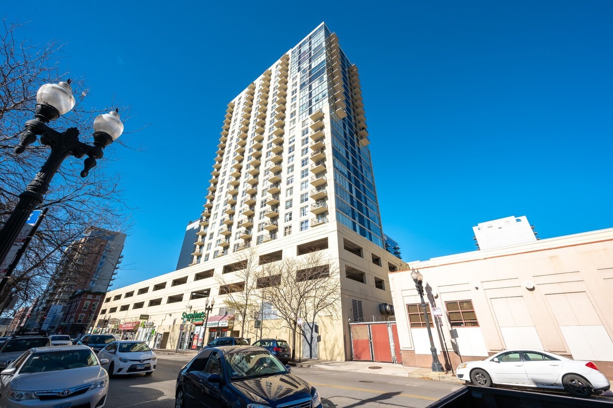 a view of a building with cars parked