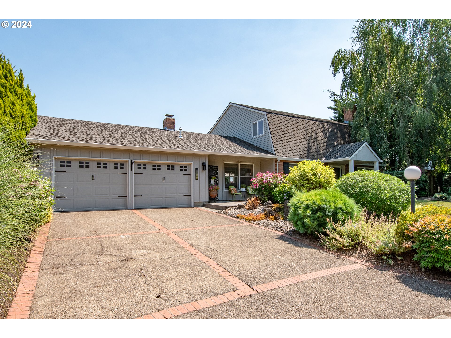 a front view of a house with a yard and a garage