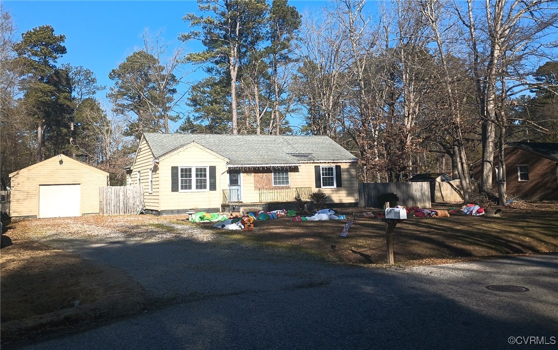 View of front of property with an outbuilding and