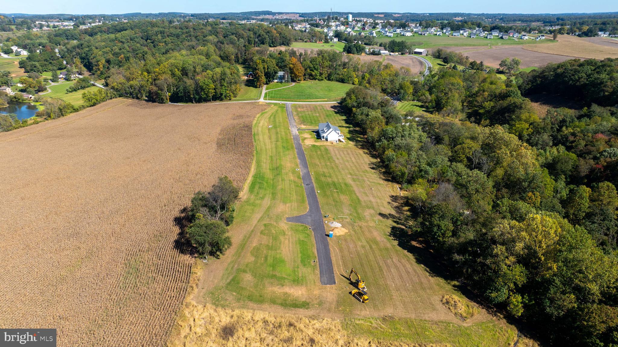 an aerial view of a house with a yard and lake view