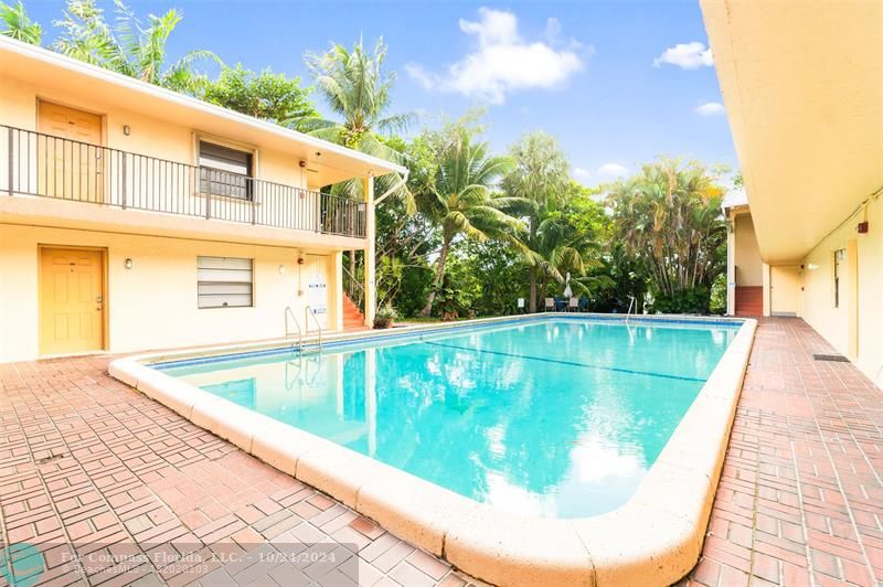 a view of a swimming pool with a yard