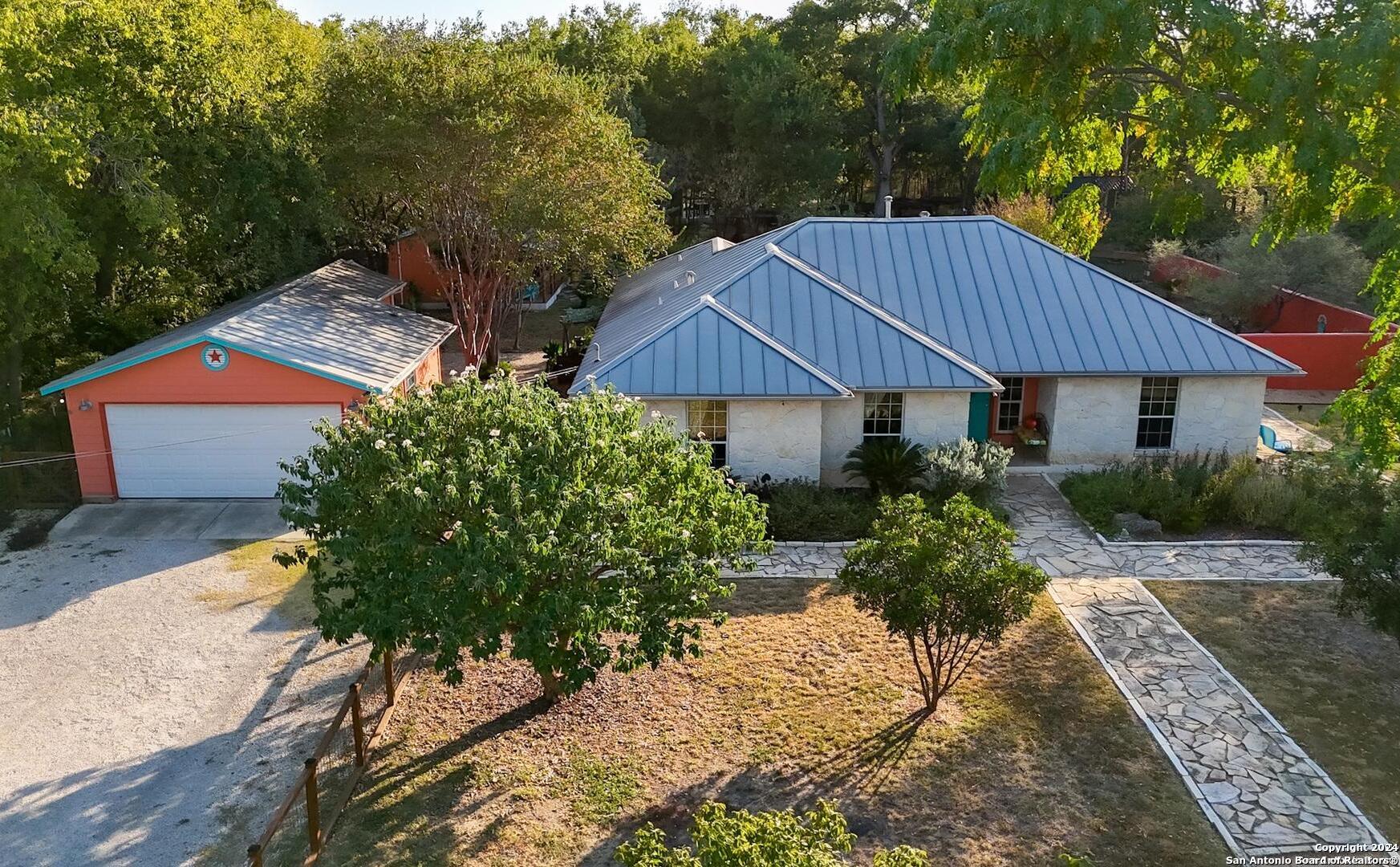 a view of a house with a yard and sitting area