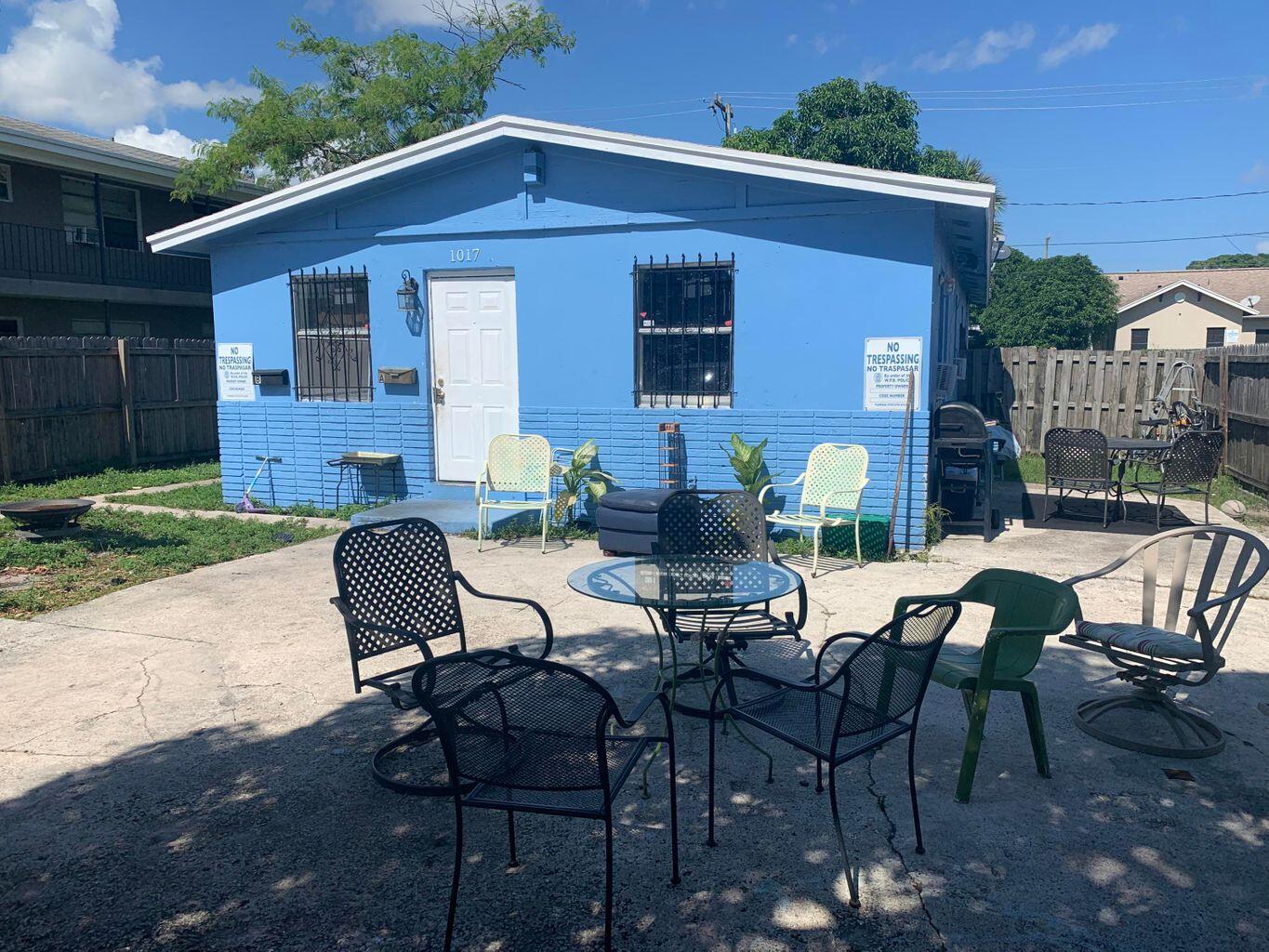 a view of a patio with table and chairs and potted plants