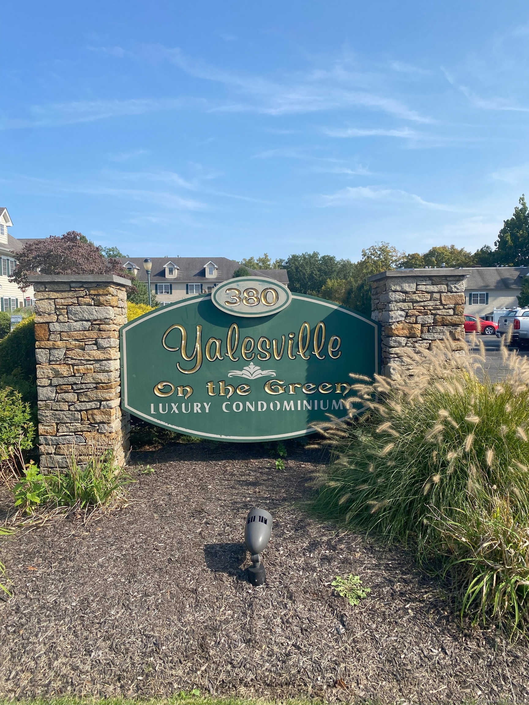 a sign board with a play ground in the back