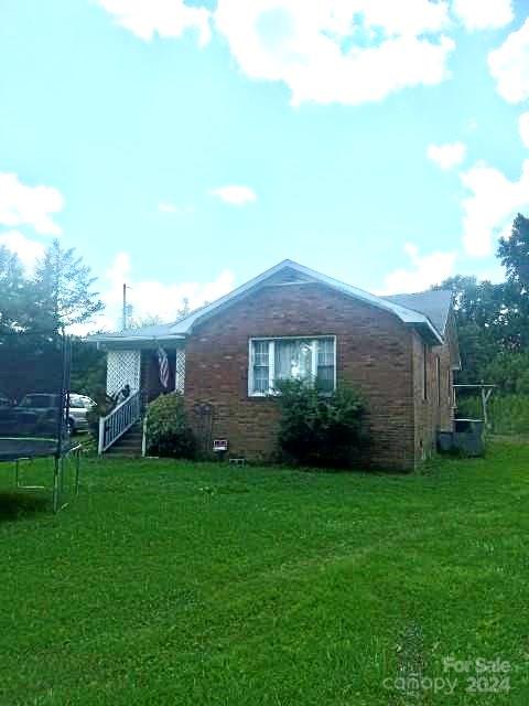 a view of a brick house with a yard