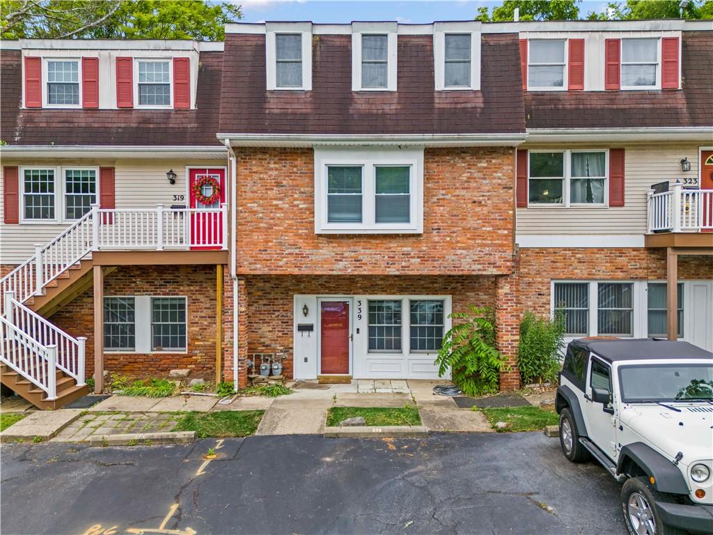 a front view of a residential apartment building with a yard