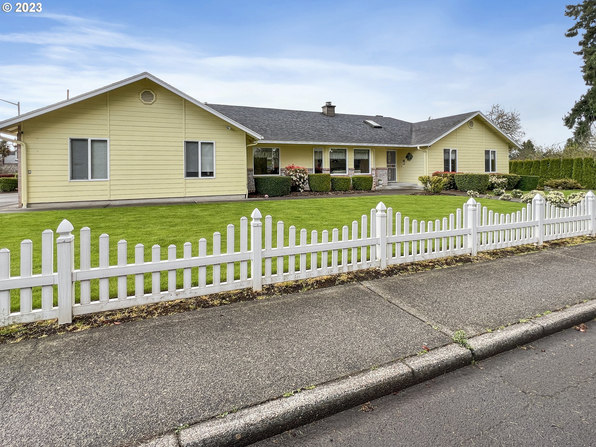 a view of a house with a wooden fence