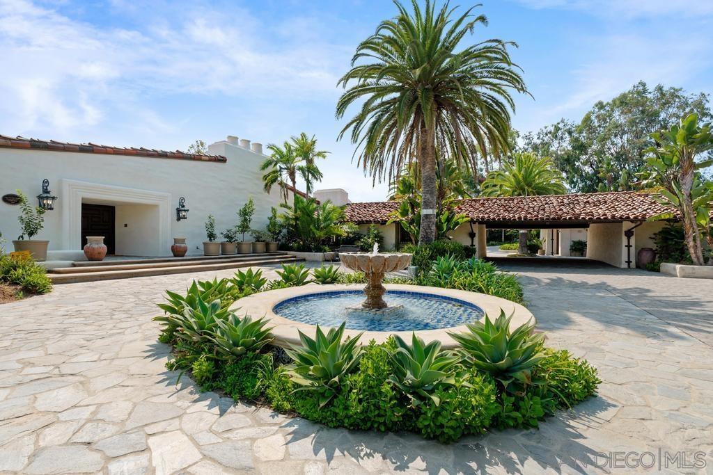 a front view of house with yard and swimming pool