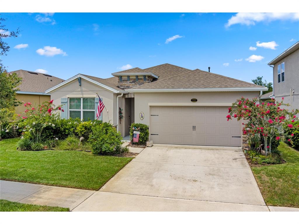 a front view of a house with a yard and garage