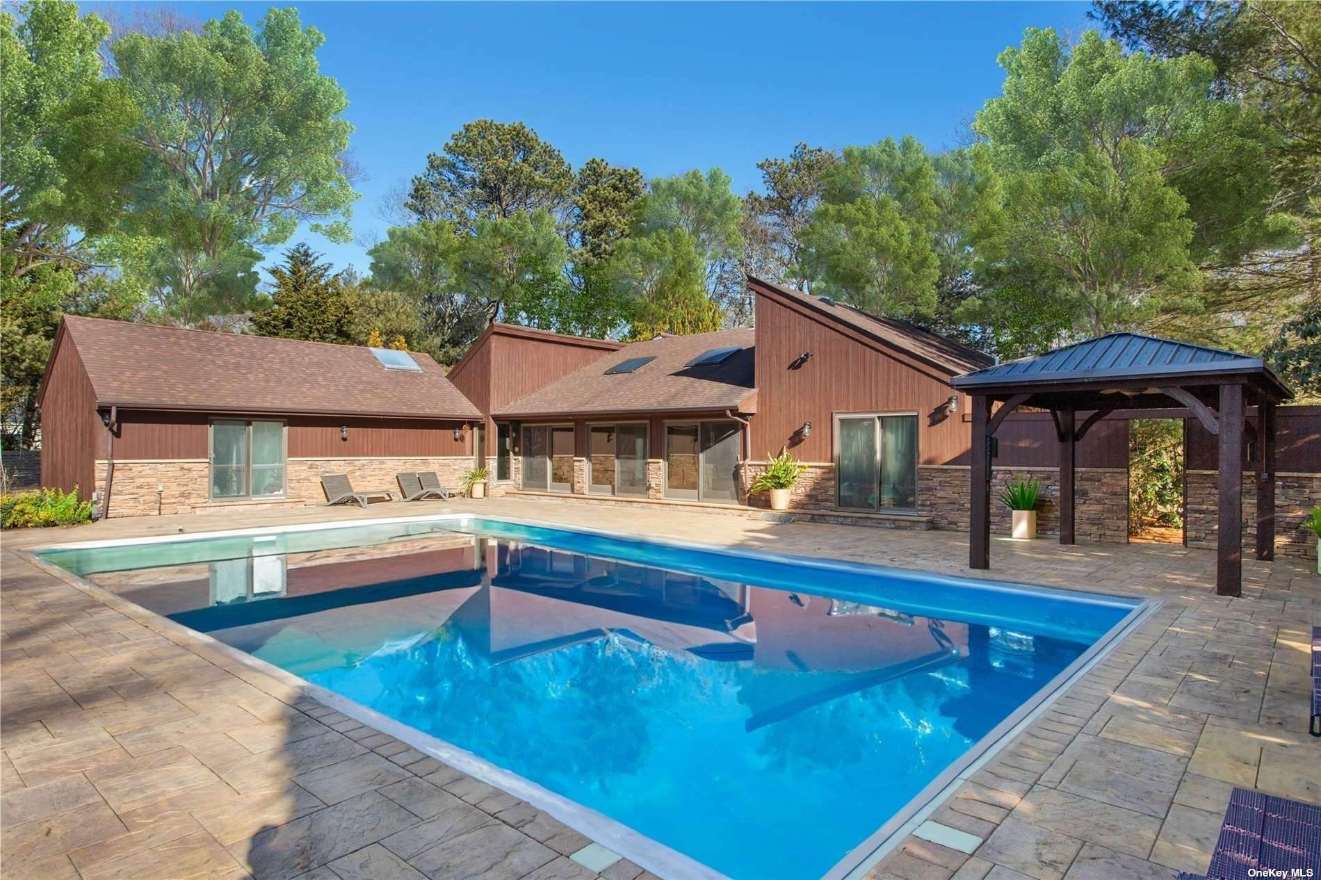 swimming pool view with a seating space and a garden view