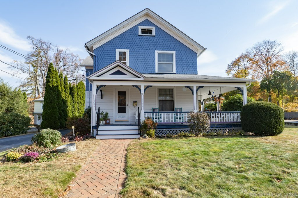 a front view of a house with a yard outdoor seating and barbeque oven