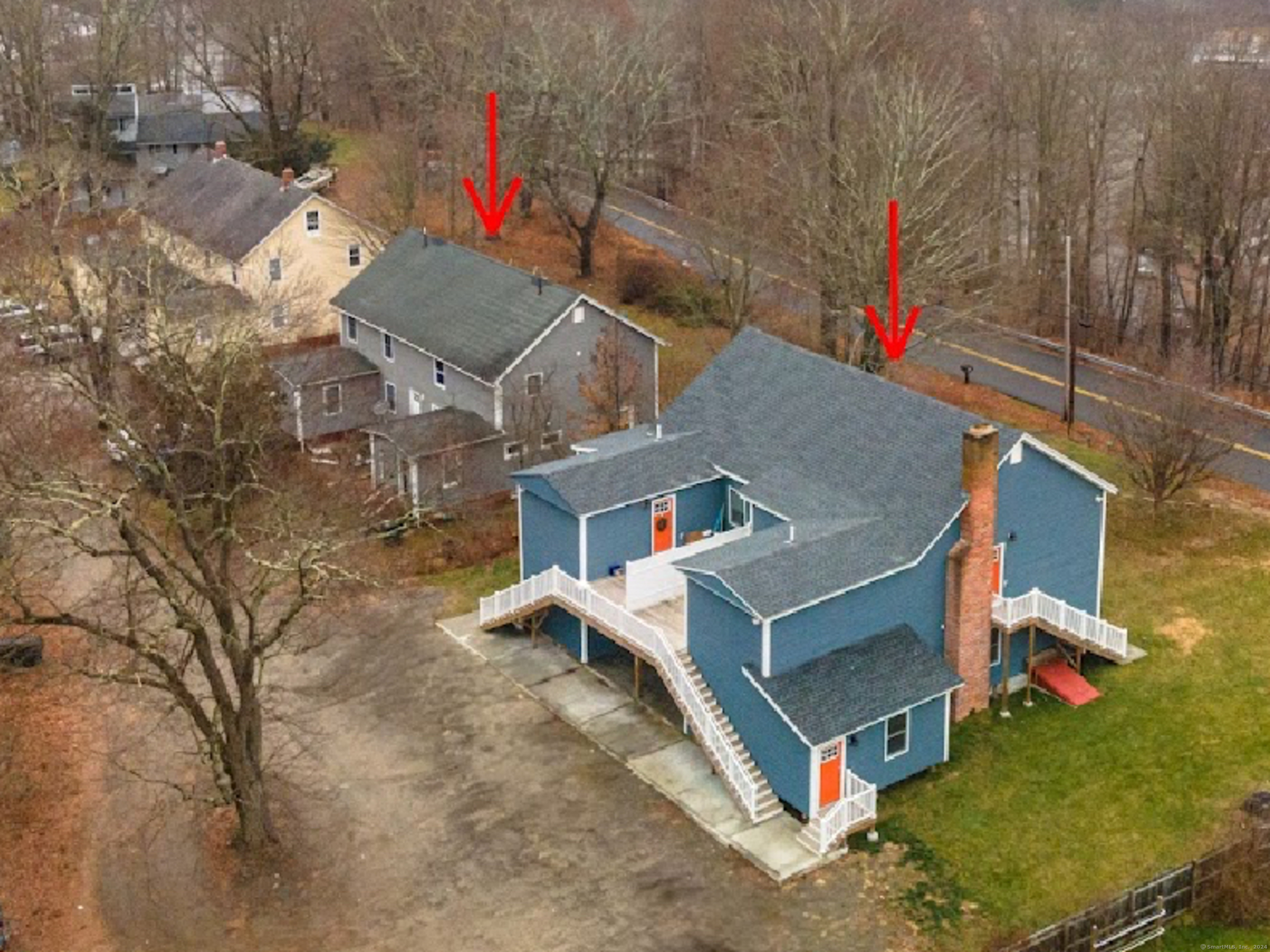 an aerial view of a house with a yard