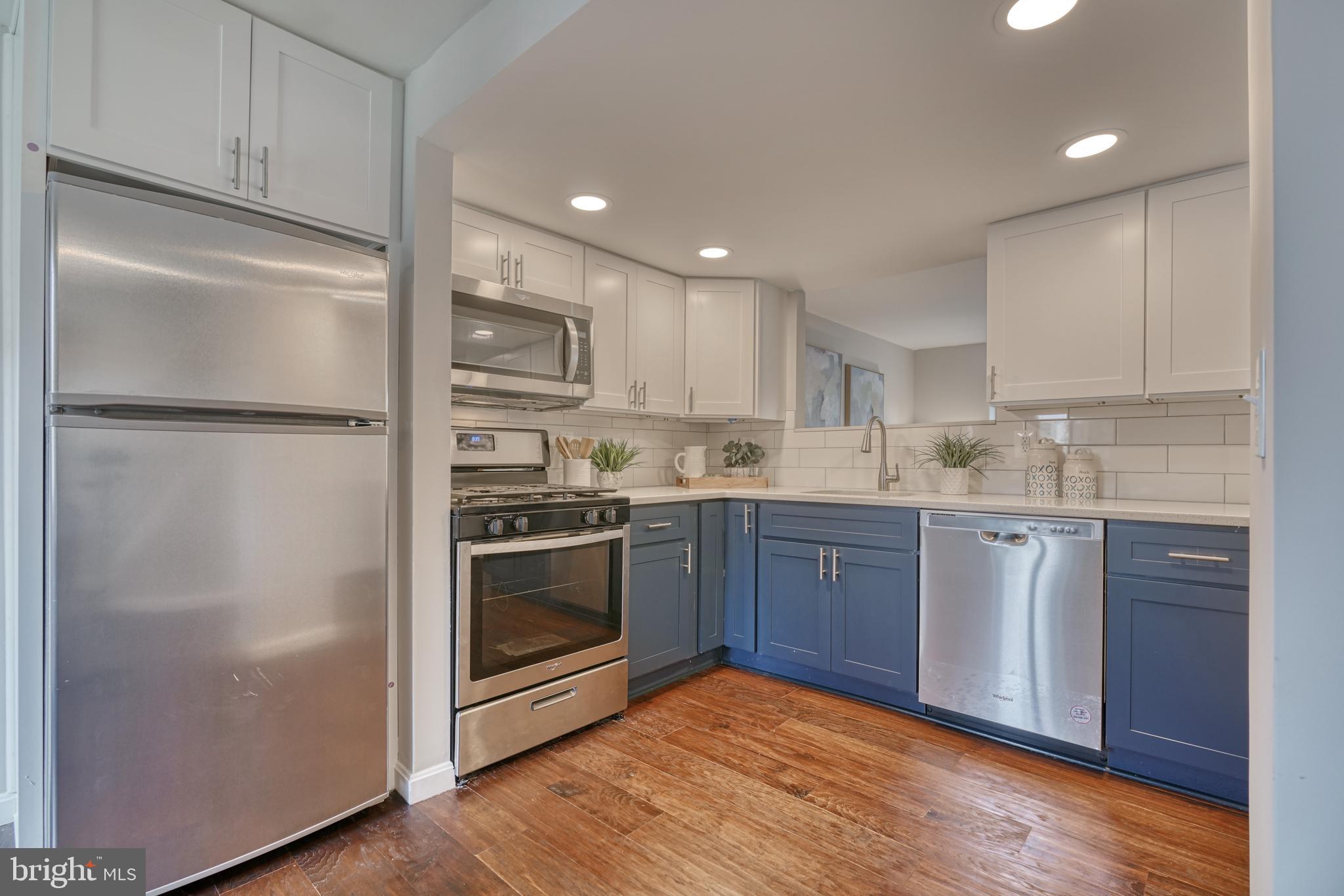 a kitchen with a refrigerator stove and sink