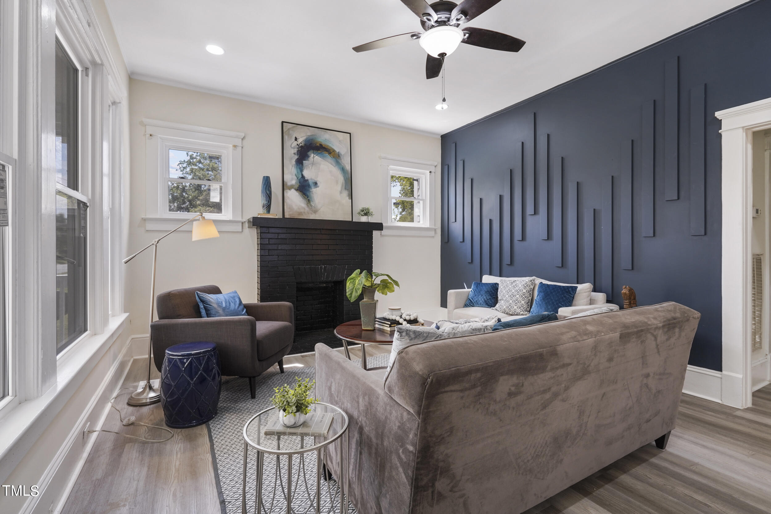 a living room with furniture a fireplace and a chandelier