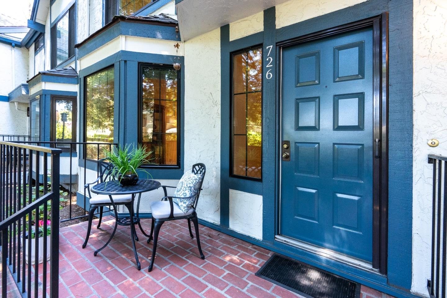 a view of a porch with a table and chairs