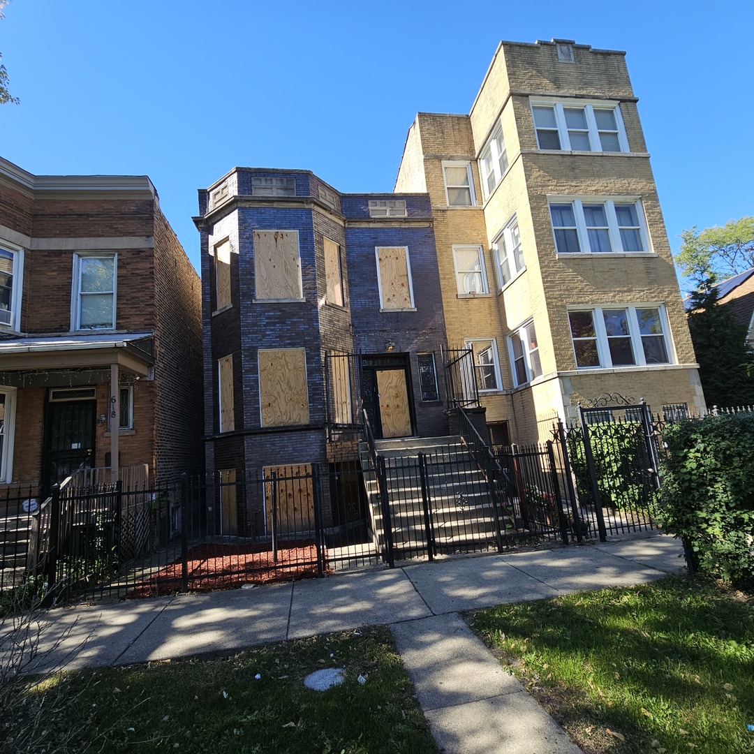 a front view of a residential apartment building with a yard