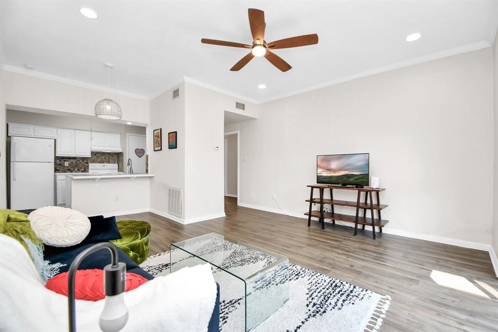 a living room with furniture and kitchen view