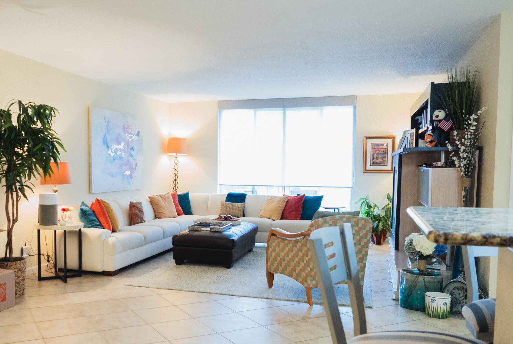 a living room with furniture and a large window