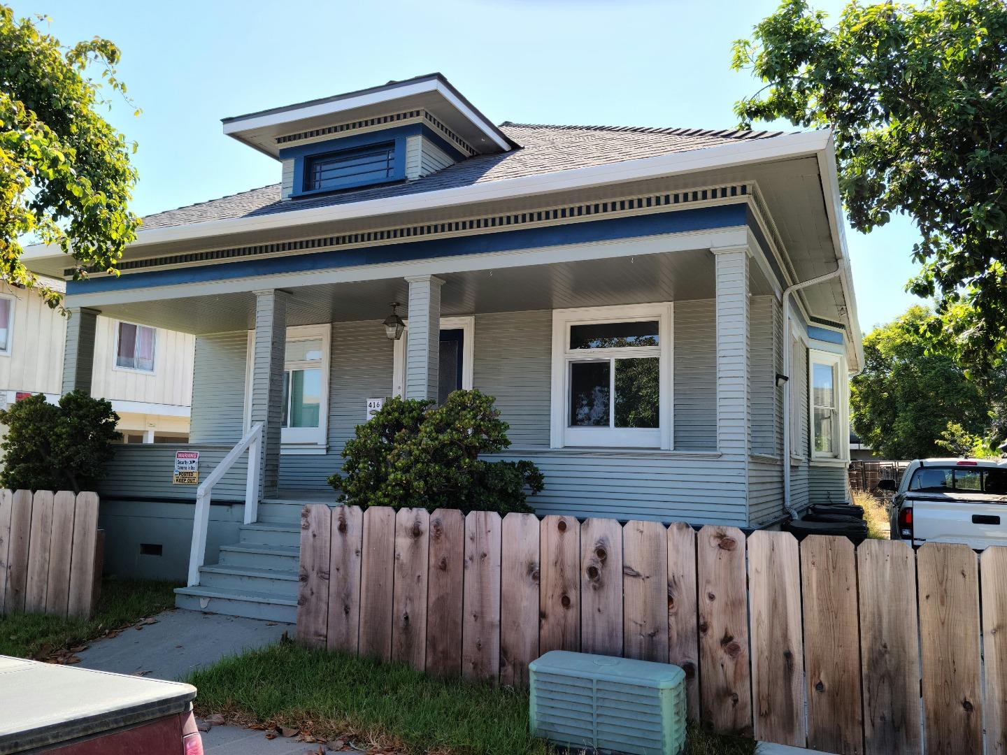 a front view of house with a garden