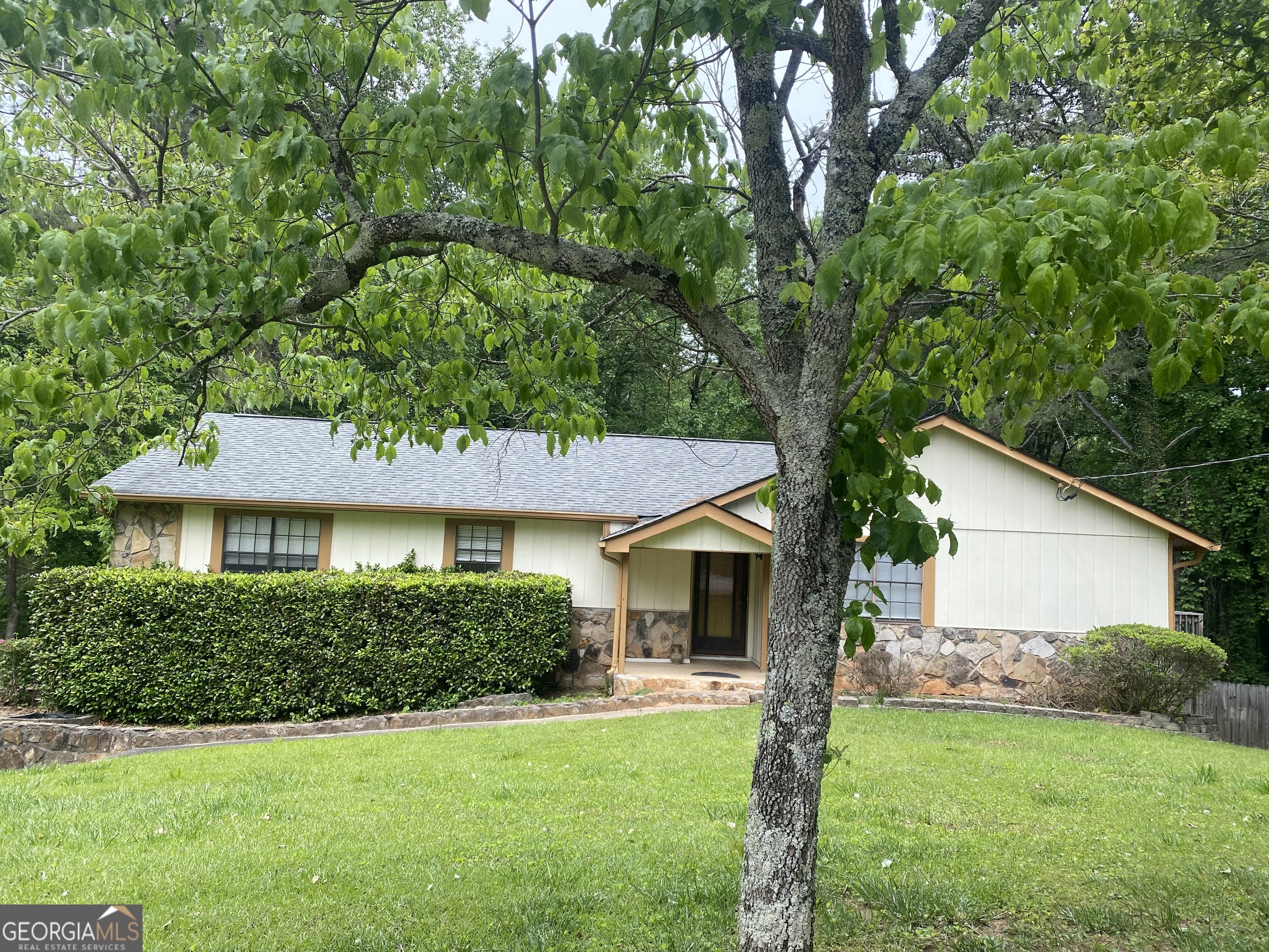 a front view of a house with a garden