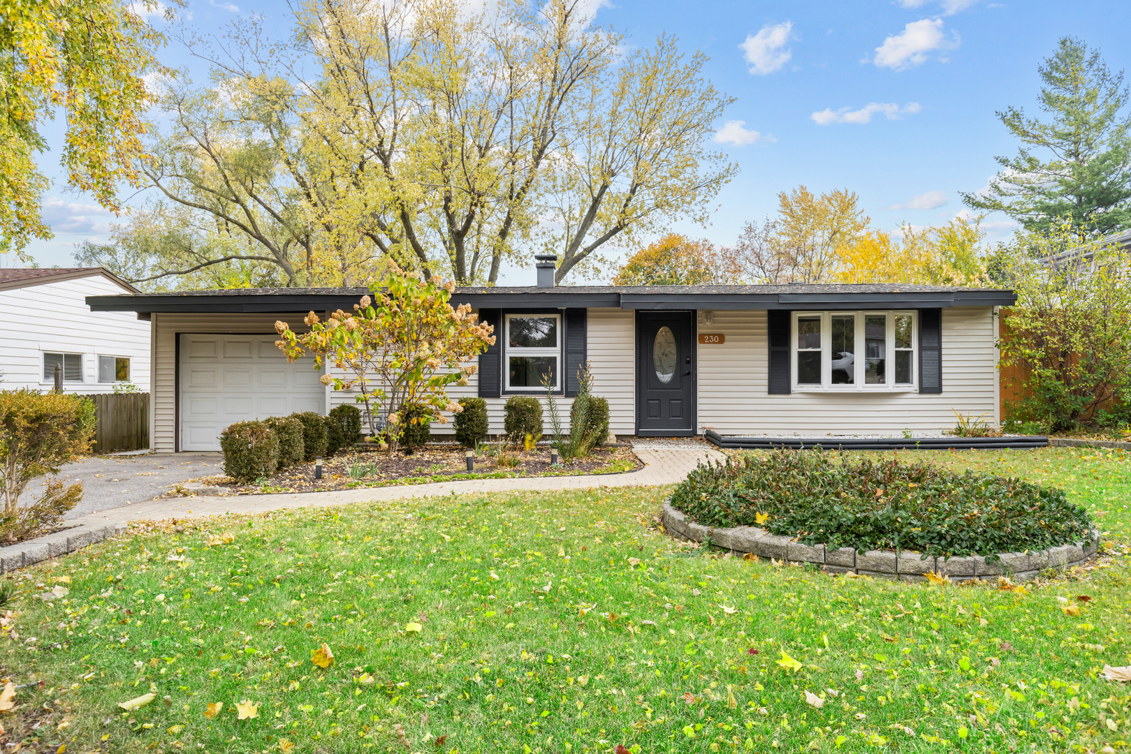 a front view of a house with yard and seating area