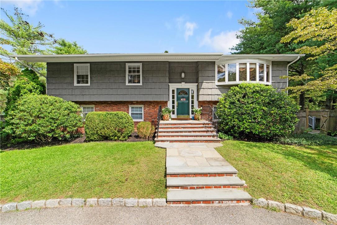 A circular driveway and beautifully landscaped property introduces this wonderful house.