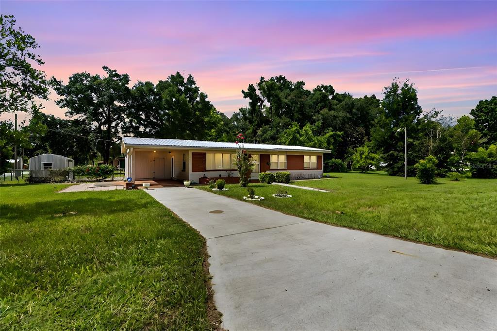 a front view of house with yard and green space