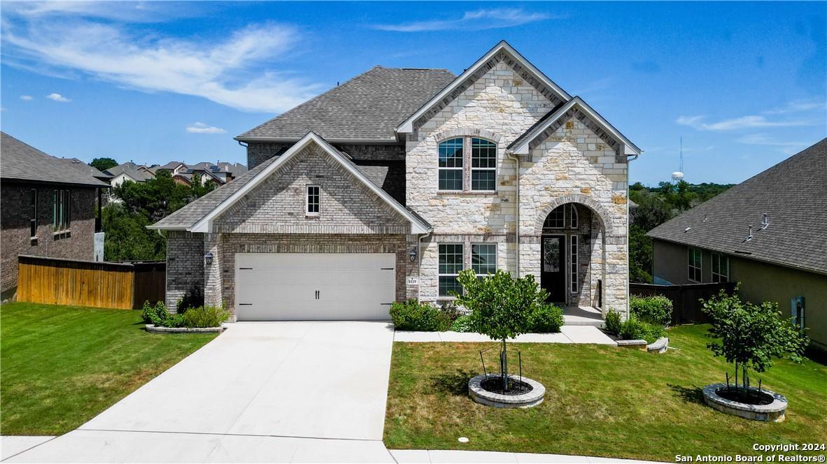 a front view of a house with a yard and garage