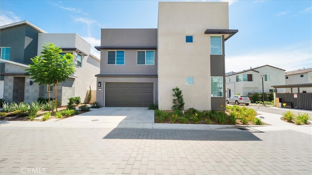 a front view of a house with a yard and a garage