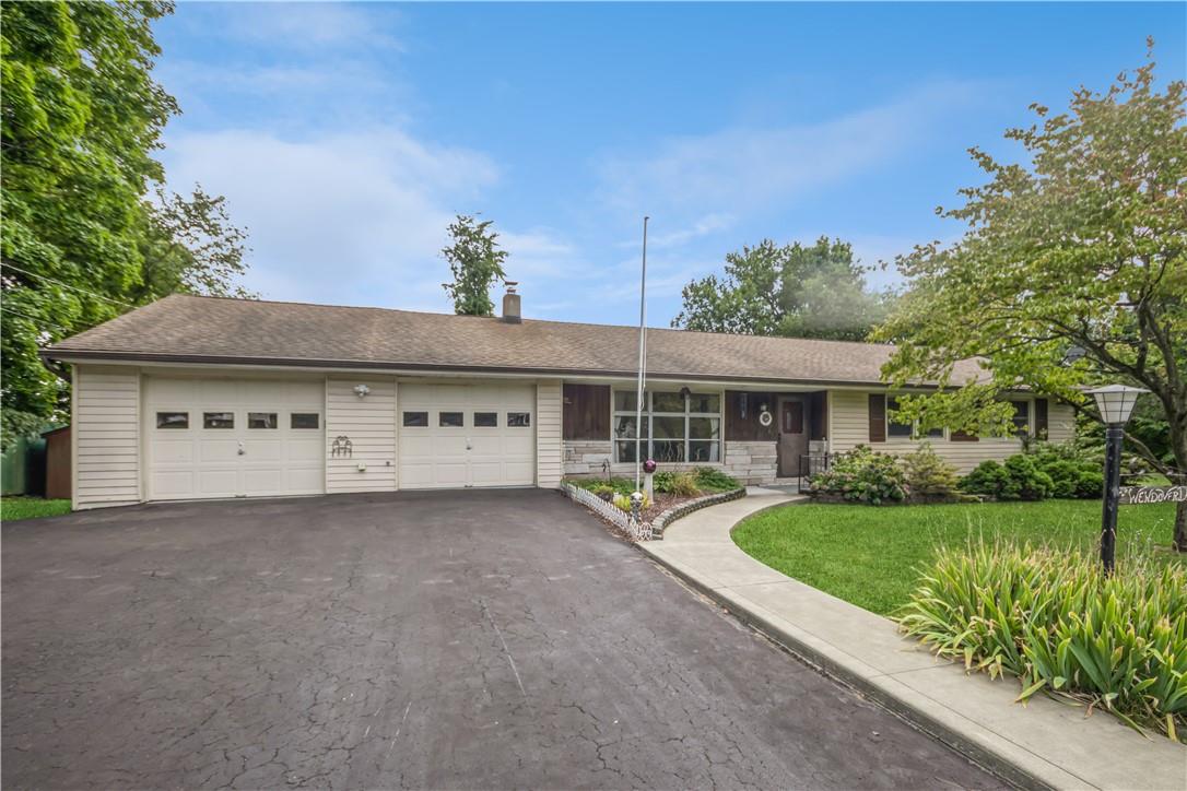 Ranch-style home with a garage and a front lawn