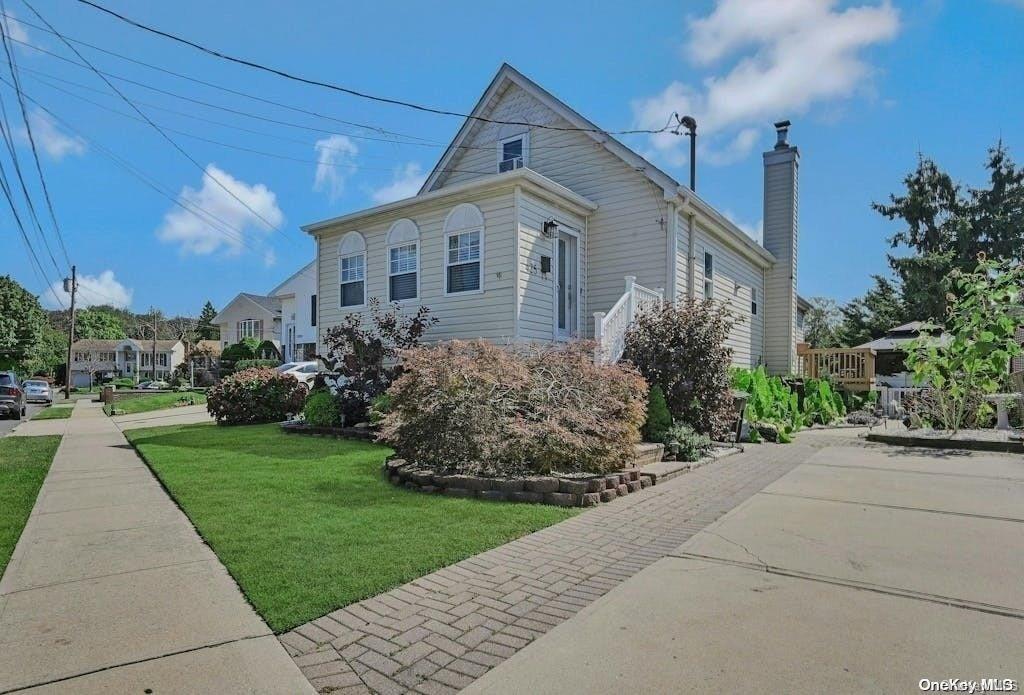 a front view of a house with a garden