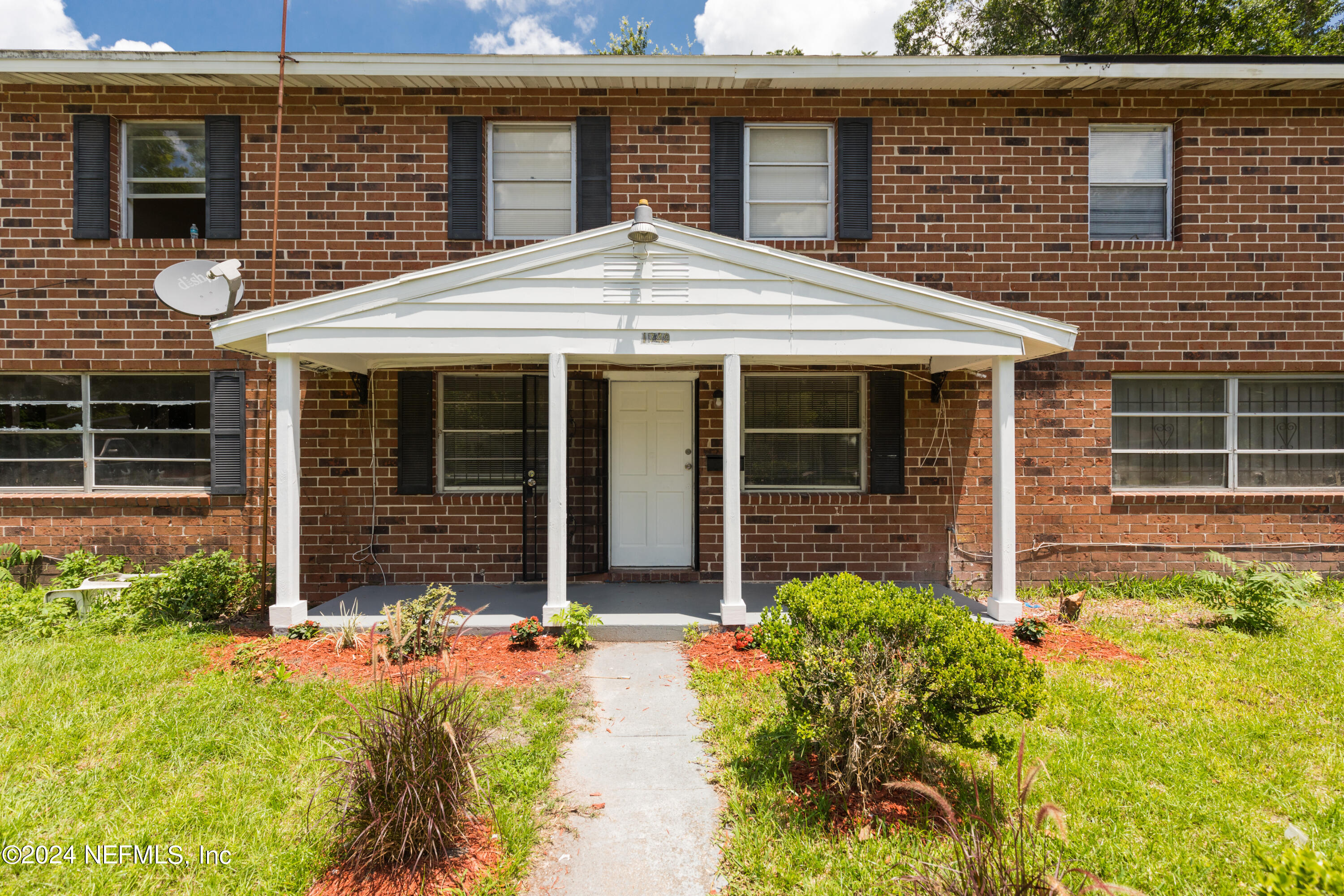 a front view of a house with garden