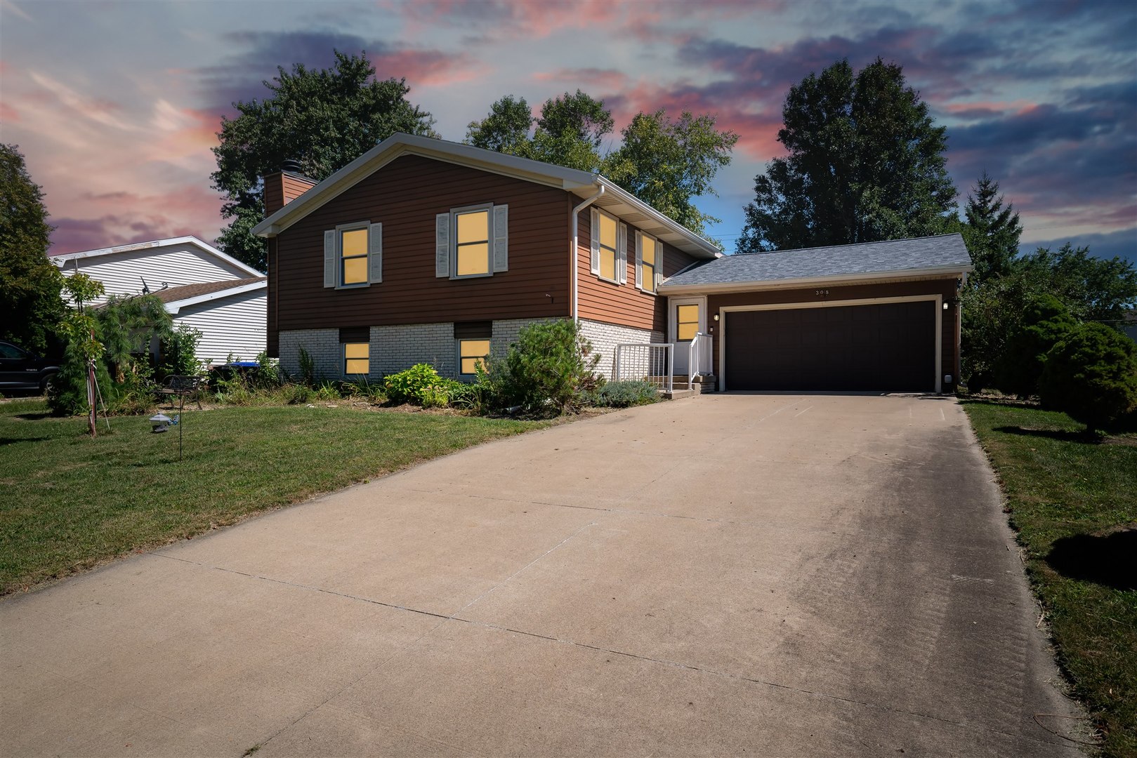 a front view of a house with a yard and garage