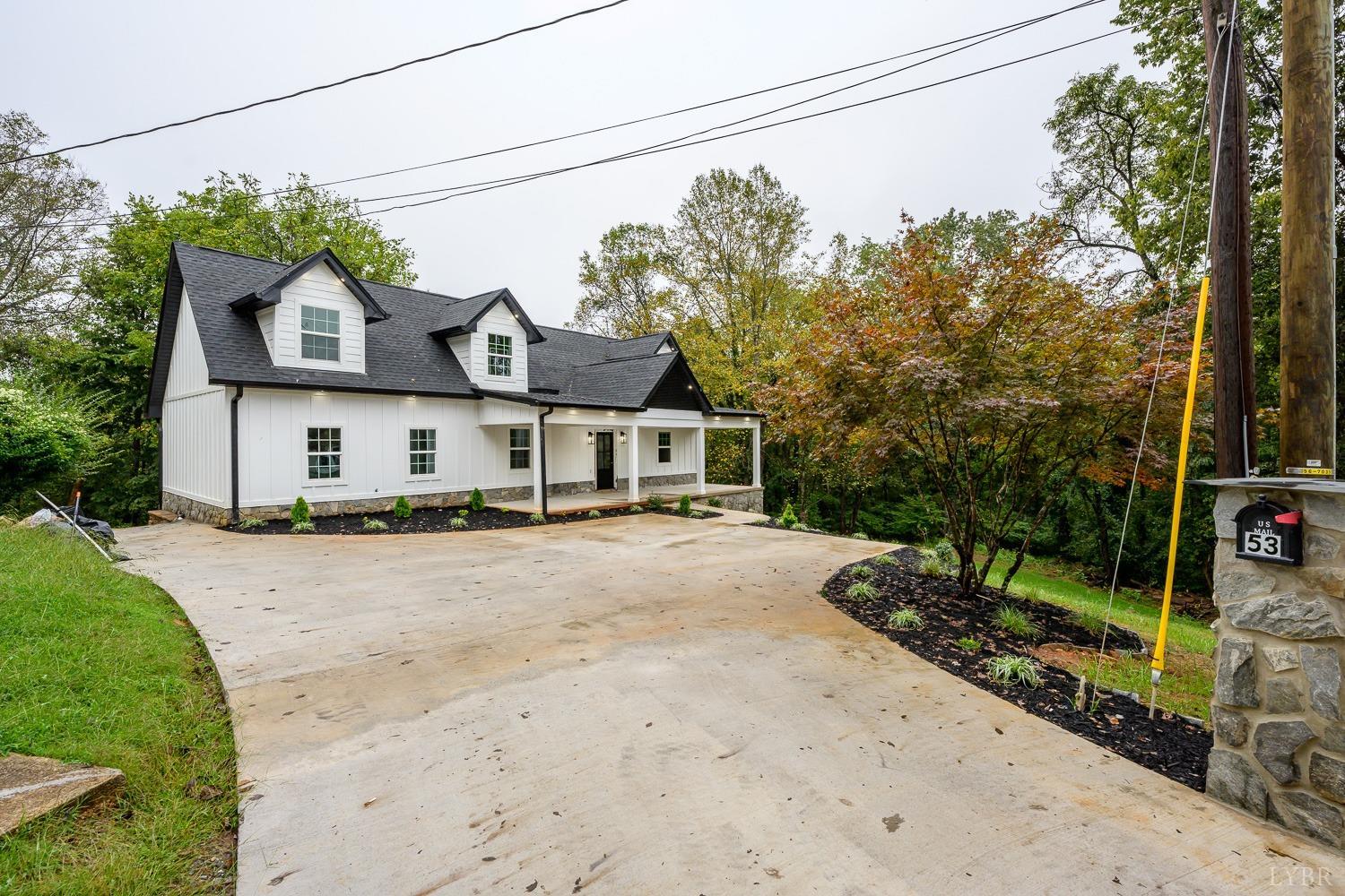 a front view of a house with a garden and street view