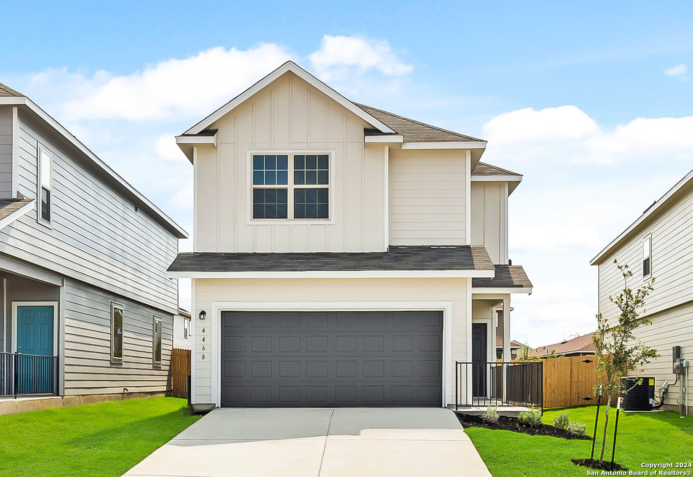 a front view of a house with a garden and garage