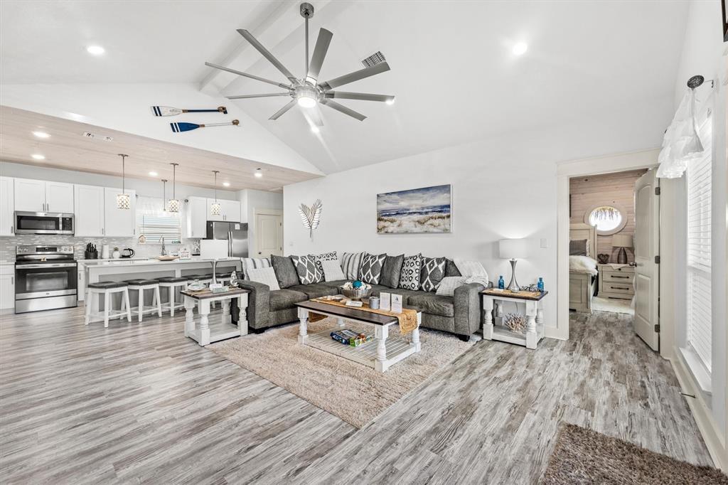 a living room with furniture and kitchen view