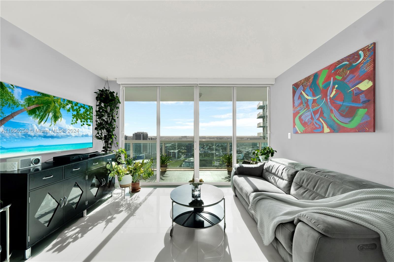 a living room with furniture and a flat screen tv