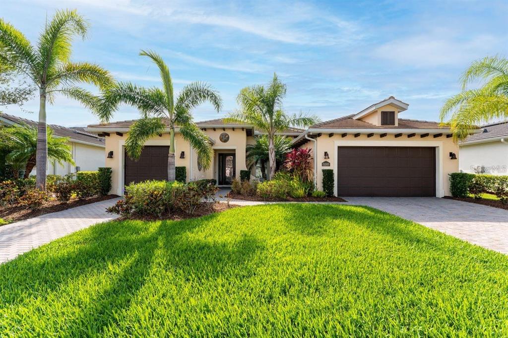 a front view of a house with a yard and garage