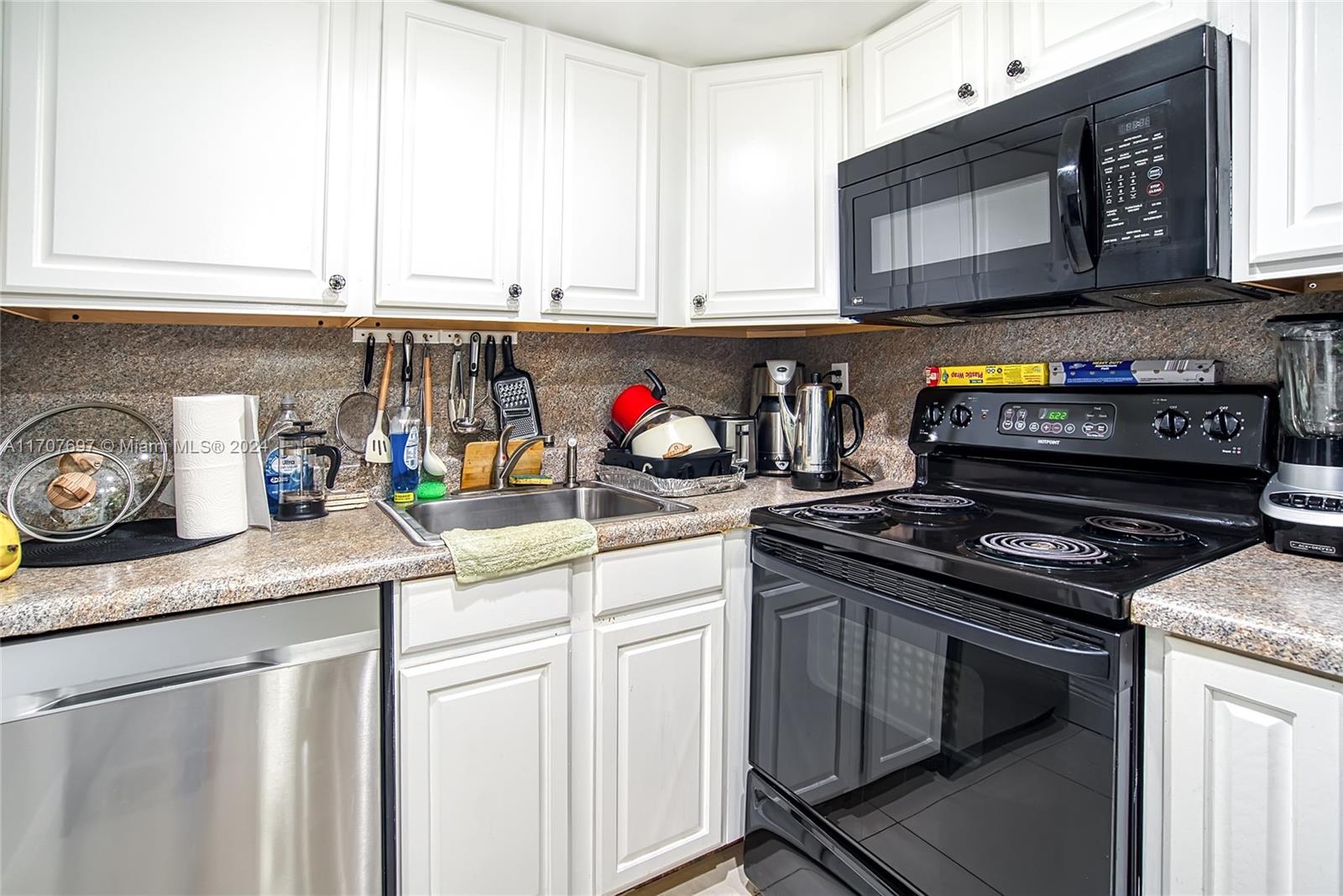 a kitchen with stainless steel appliances granite countertop a stove a microwave and cabinets