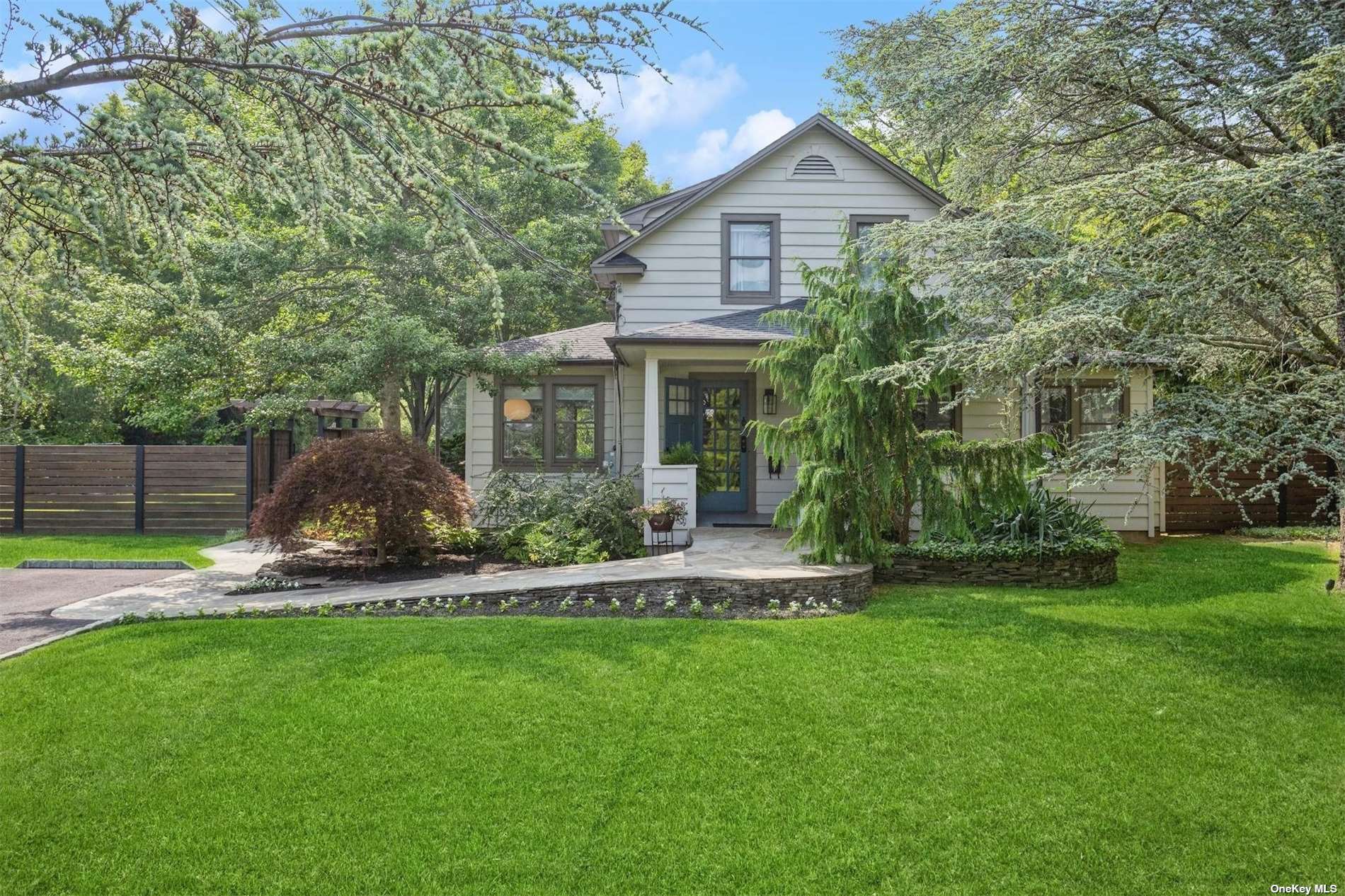 a front view of a house with garden and porch