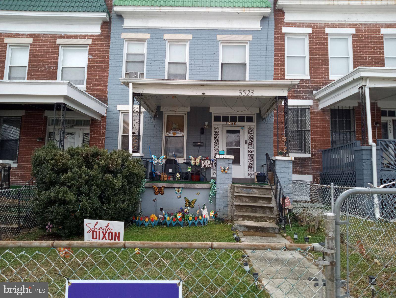 a front view of a multi story building with yard