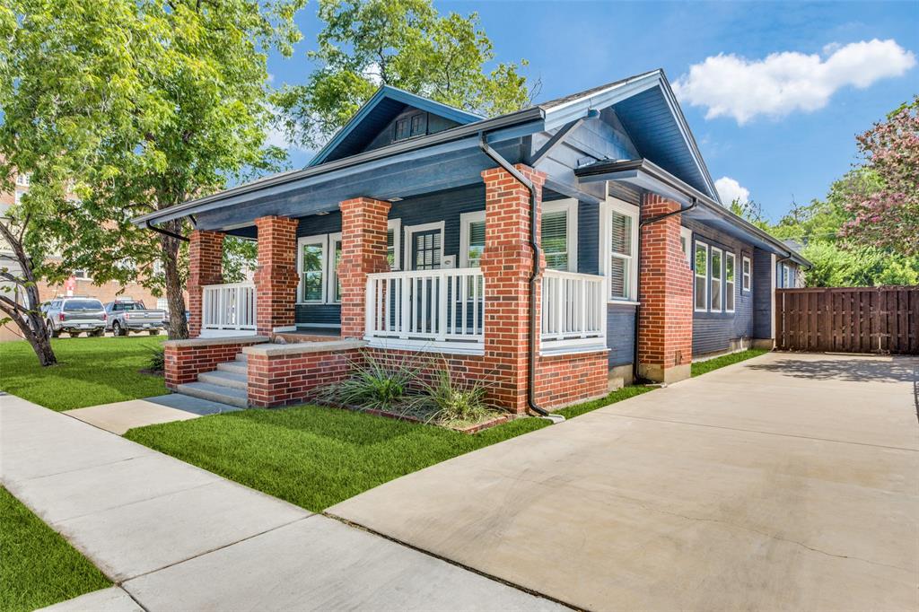 a front view of a house with a yard and fence