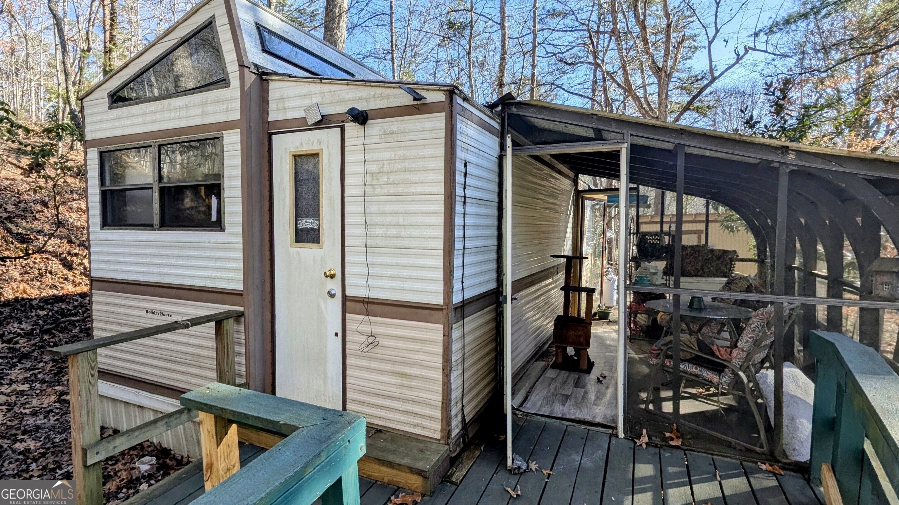 a view of a house with backyard and deck