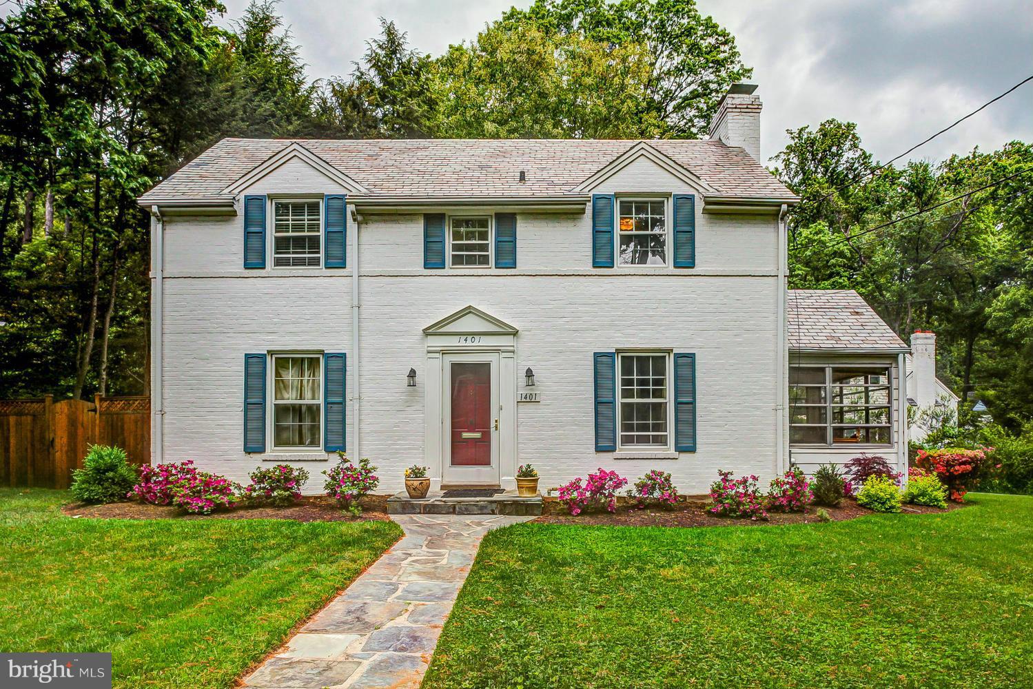 a front view of a house with a garden and porch