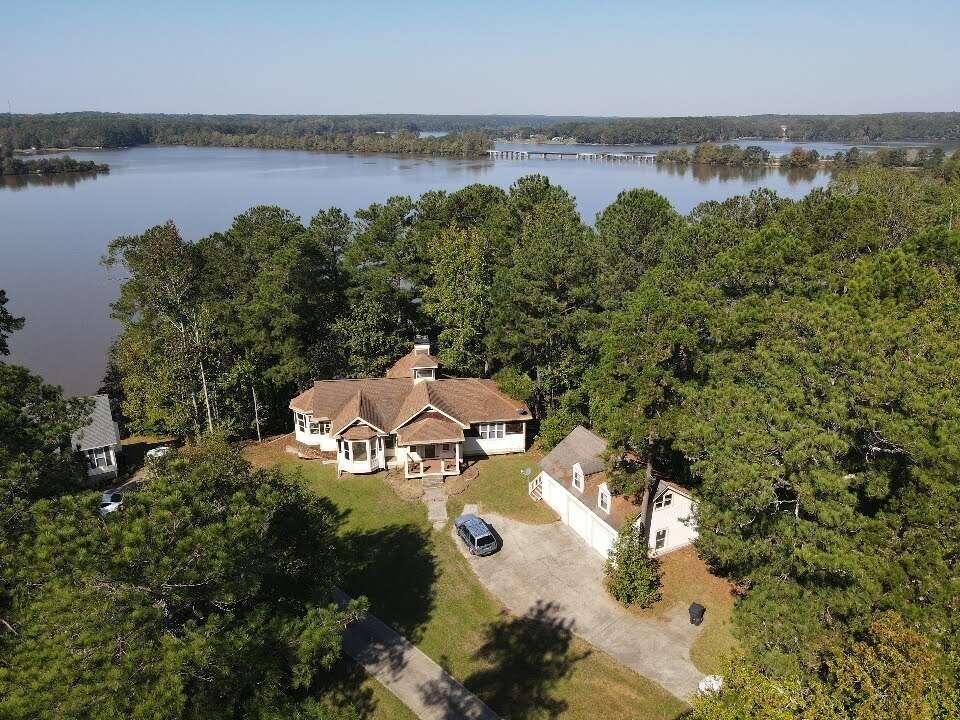 an aerial view of a house with garden space and outdoor seating