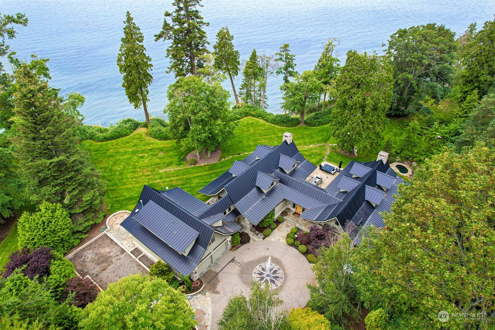 an aerial view of a house with garden space and street view