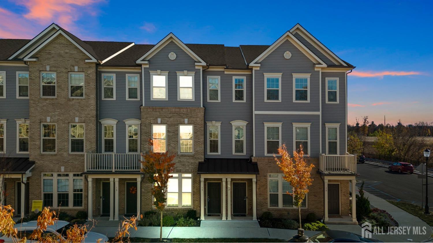 a front view of a residential apartment building with a yard